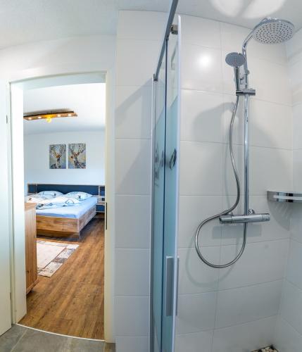 a bathroom with a shower and a bedroom at Appartements Bergwelt in Oetz