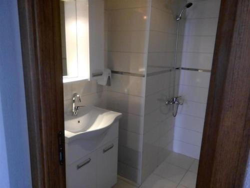a white bathroom with a sink and a shower at Dolunaydın Butik Otel in Side