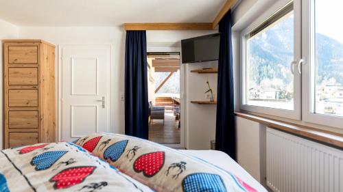 a bedroom with a bed and a window at Appartements Bergwelt in Oetz