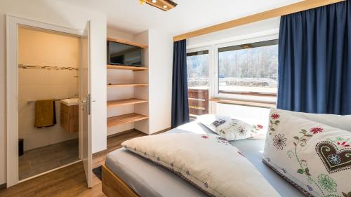a small bedroom with a bed and a window at Appartements Bergwelt in Oetz