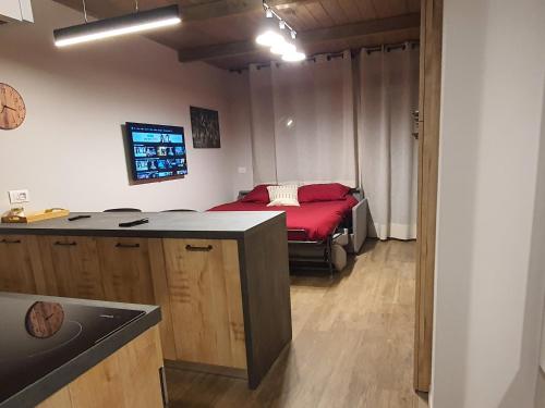 a kitchen with a bed in the corner of a room at Moda Apartments Scalette in Sestriere