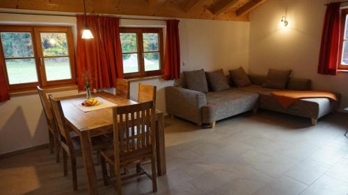 a living room with a couch and a table at Hölzlhof in Amerang