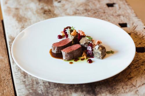 a white plate with a piece of food on a table at PENSION Hinterleithner in Persenbeug-Gottsdorf