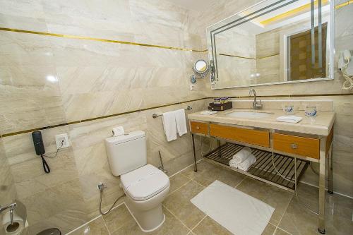 a bathroom with a toilet and a sink at Pickalbatros Aqua Blu Sharm El Sheikh in Sharm El Sheikh