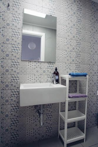 a bathroom with a white sink and a mirror at Grand Hostel Manin in La Spezia