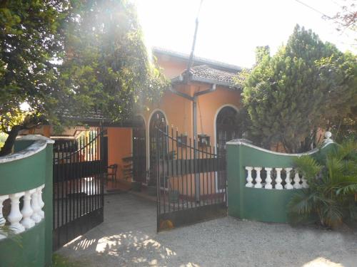 a gate in front of a house with a building at Negombo Lagoon Villa in Negombo