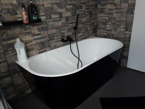 a bath tub in a bathroom with a bottle of soap at D'n Engel in Sittard