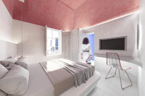 a bedroom with a bed and a tv and a chair at Kykladonisia Traditional Settlement in Fira