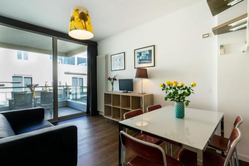 a living room with a table and chairs at Hotel Cristallo in Rimini