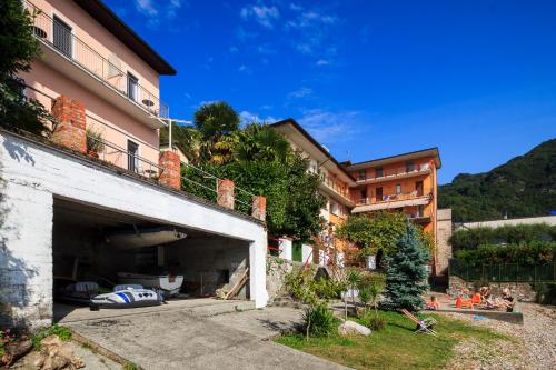 an apartment building with a garage in front of it at Miralago Casa in Menaggio