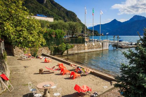 a group of people laying on the beach near the water at Miralago Casa in Menaggio