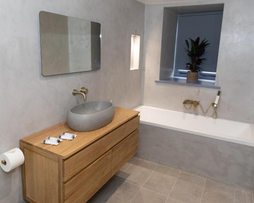 a bathroom with a sink and a bath tub at The Nog Inn in Wincanton