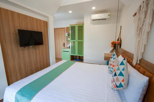 a bedroom with a bed and a flat screen tv at The View Hotel in Cam Lâm