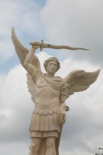 a statue of an angel holding a racket at Salvatores Grand Hotel in Williamsville