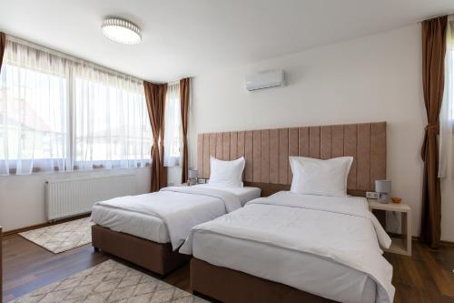 Postel nebo postele na pokoji v ubytování Malak Resort Sarajevo