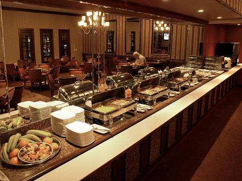 a buffet line in a hotel with food on it at Salvatores Grand Hotel in Williamsville
