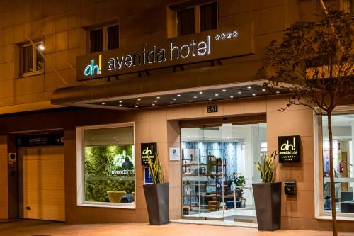 a store front of a building with a sign on it at Avenida Hotel in Almería