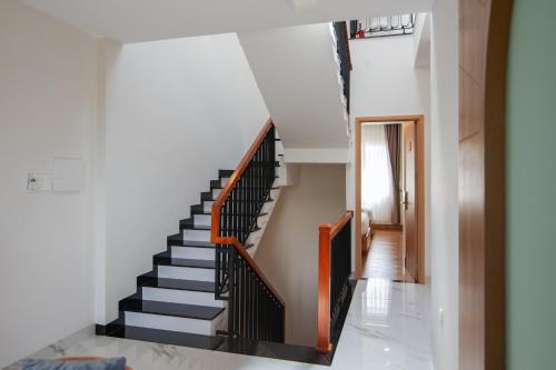 a staircase in a house with black and white stairs at The View Hotel in Cam Lâm
