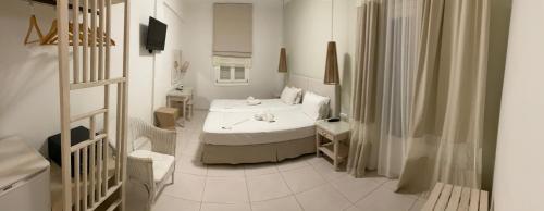 a white room with a bed and a television at Hotel Benois in Galissas