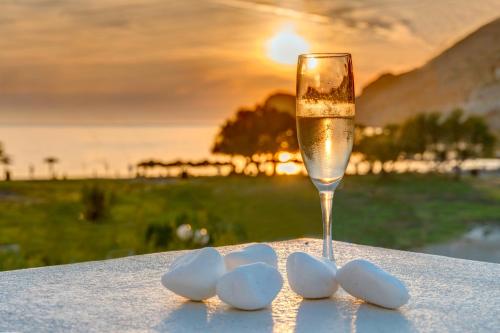 a glass of champagne and a group of white rocks at Hotel Benois in Galissas