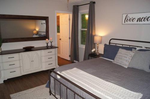 a bedroom with a bed and a large mirror at Less than 3 miles to Downtown with firepit in Ellijay