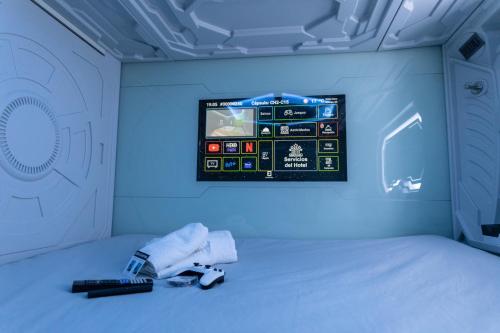 a room with a bed with a remote control on it at Futurotel Malagueta Beach in Málaga
