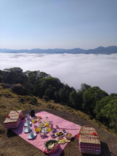 a picnic table with food on top of a mountain at Sitio do Galdino in Armazém