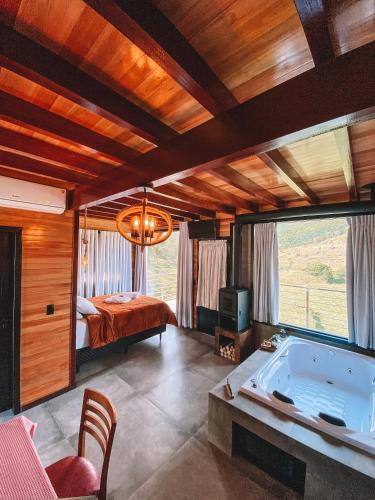 a bedroom with a bed and a tub in a room at Sitio do Galdino in Armazém