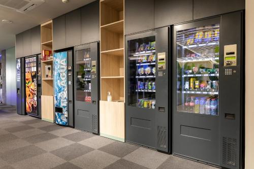 a row of vending machines with drinks in them at Futurotel Malagueta Beach in Málaga