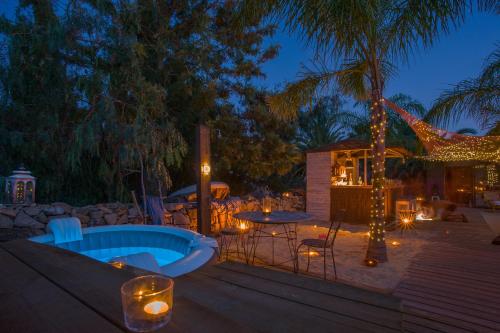 a backyard with a hot tub and a patio with lights at Casa Liberdade in Faro