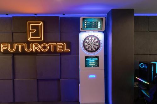 a dart machine in a room with a sign at Futurotel Malagueta Beach in Málaga