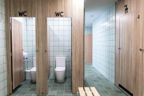 a bathroom with two toilets and two stalls at Futurotel Malagueta Beach in Málaga