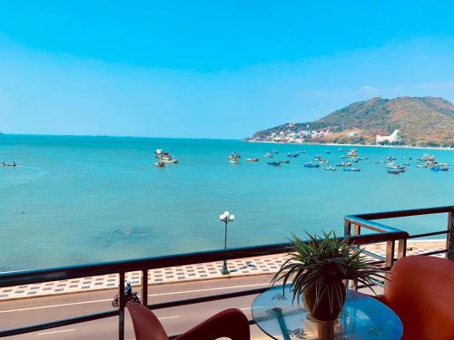 a balcony with a view of the water with boats at Lucys Hotel in Vung Tau