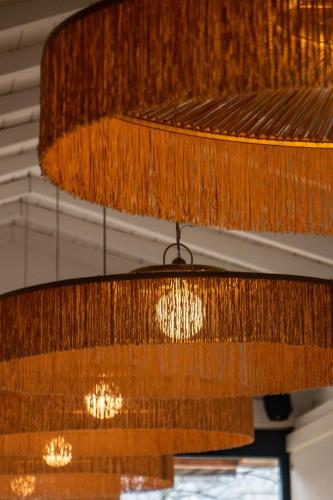 a large wooden chandelier hanging from a ceiling at Best Western Porte du Forez in Andrézieux-Bouthéon