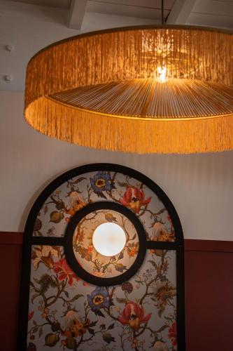 a large ceiling fan and a large light fixture at Best Western Porte du Forez in Andrézieux-Bouthéon