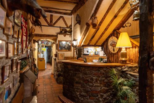 a bar in a building with a stone wall at Hotel La Bonne Auberge in Saint-Martin-Vésubie