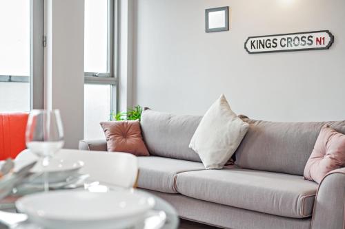 a living room with a couch and a table at Lux 2 & 3 Bed Apartments in Camden Town FREE WIFI by City Stay Aparts London in London