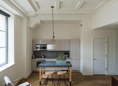 a kitchen with a table and chairs in a room at ROOST Midtown in Philadelphia