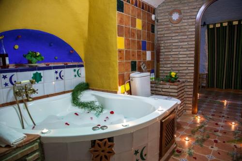 a bathroom with a tub with a dinosaur in it at Casas Cueva Cazorla in Hinojares
