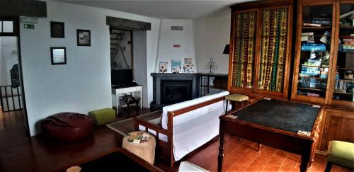 a living room with a table and a fireplace at Quinta do Bom Despacho in Ponta Delgada