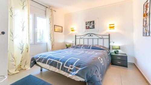 a bedroom with a large bed and a window at VACAY Villa Camí in L'Escala
