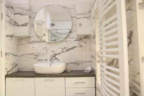 a bathroom with a sink and a mirror at Natalie's Royal M in Belgrade