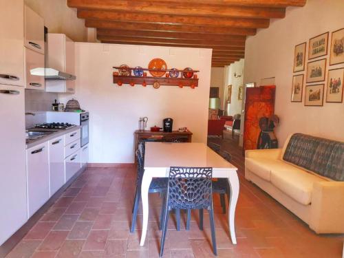 a kitchen with a table and a couch at Bosa Exclusive Apartments "Bosa Apartments" in Bosa