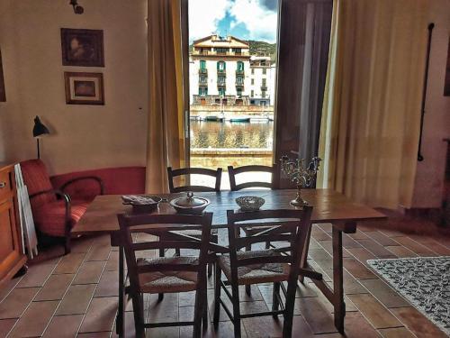 a dining room with a table and chairs and a window at Bosa Exclusive Apartments "Bosa Apartments" in Bosa