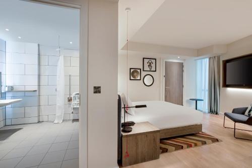a bedroom with a large bed and a bathroom at Hampton By Hilton Bath City in Bath