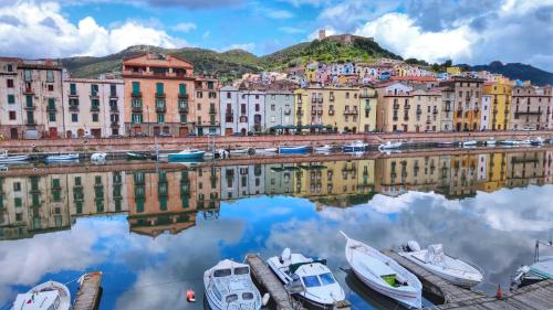 a view of a city with boats in the water at Bosa Exclusive Apartments "Bosa Apartments" in Bosa