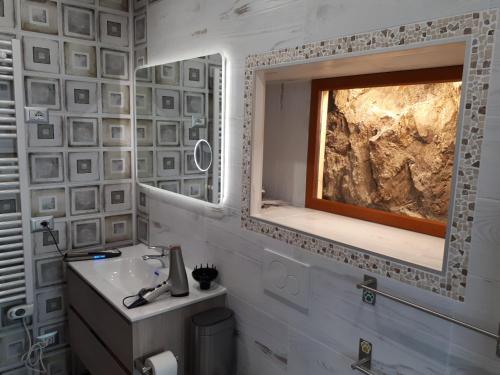 a bathroom with a sink and a window at Sole & Lago-Lake in Maccagno con Pino e Veddasca