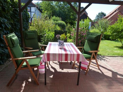 a table and four chairs with a table and a tablecloth at Landhaus Bolzum in Sehnde