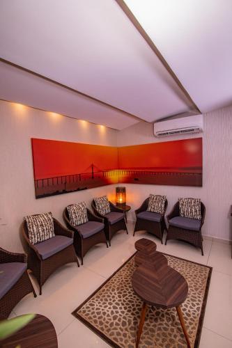 a waiting room with chairs and a table at Ramada by Wyndham Manaus Torres Center in Manaus