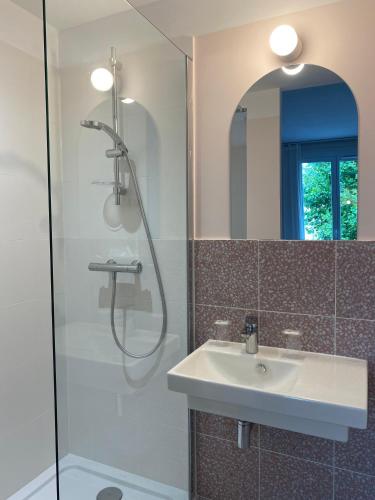 a bathroom with a sink and a shower at Hotel Saint Louis in Brest